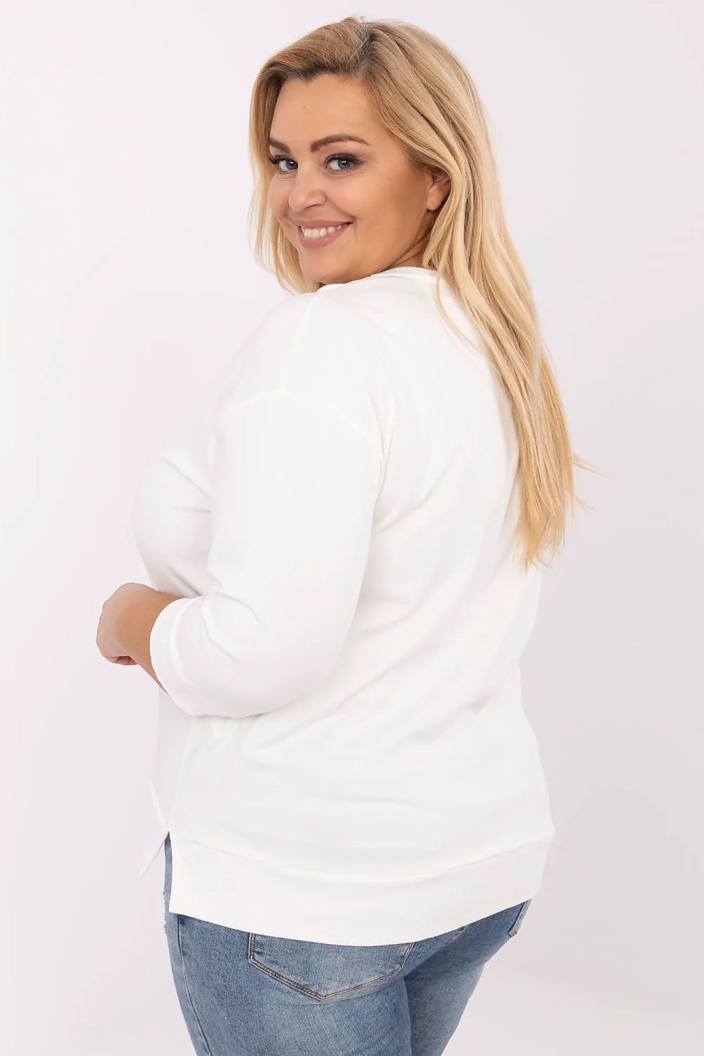 Mulher plus size de costas usando blusa preta plus size com jeans azul claro