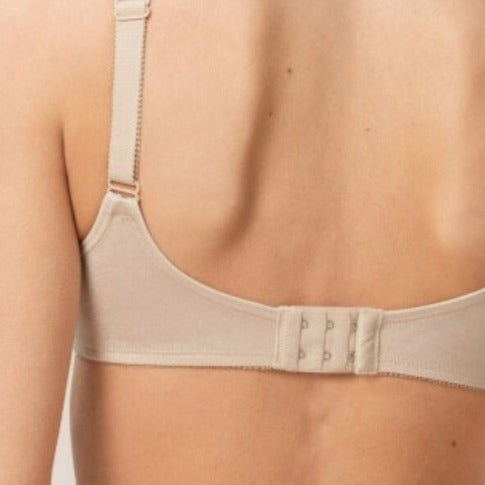 Extensor de sutien bege instalado na parte de trás de um sutiã para ajuste confortável