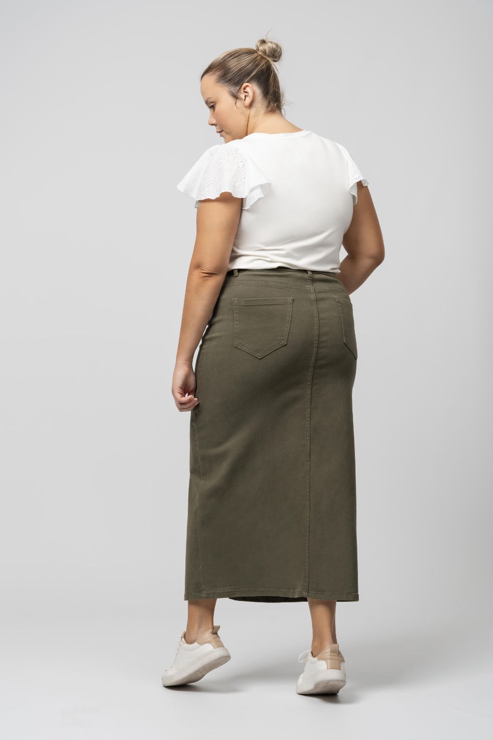 Saia denim comprida com racha verde escuro da Curvy vista de costas em modelo plus size